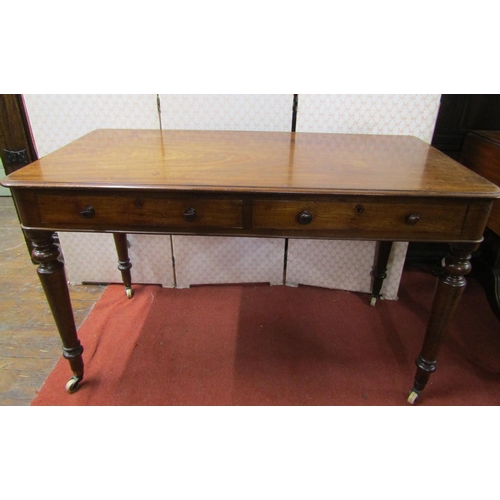 2669 - Victorian mahogany side/writing table, with two drawers on turned tapered supports, 122cm wide