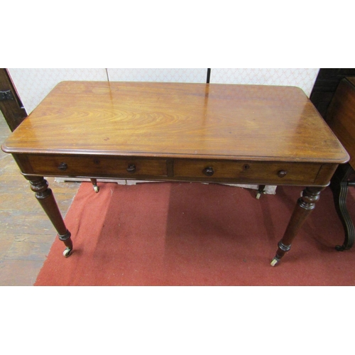 2669 - Victorian mahogany side/writing table, with two drawers on turned tapered supports, 122cm wide