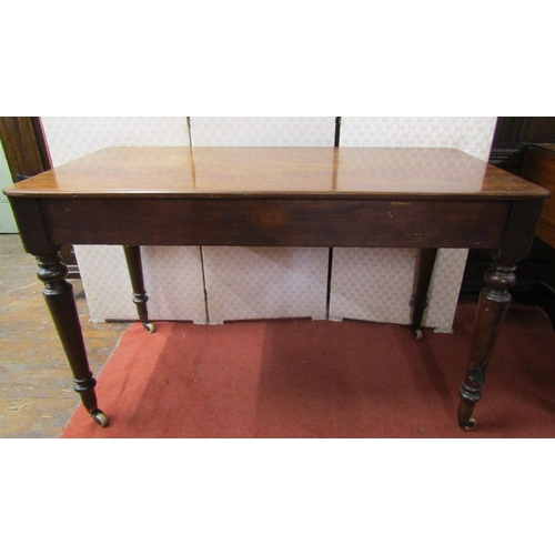 2669 - Victorian mahogany side/writing table, with two drawers on turned tapered supports, 122cm wide