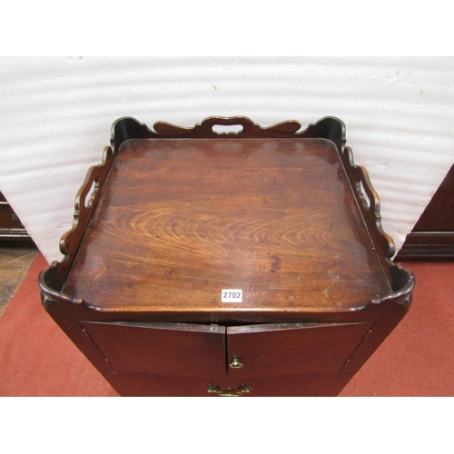 2702 - A Georgian mahogany tray top commode, with two doors and drawer, with a shaped and pierced galleried... 