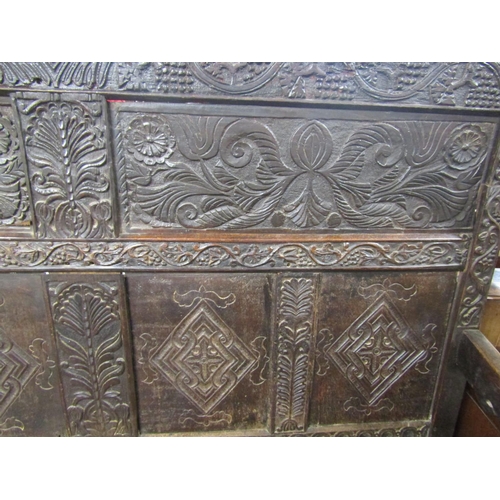 2699 - A 17th century and later box settle, with carved floral and fruiting vine detail, the crest dated 16... 