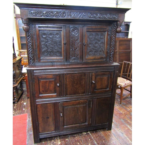 2701 - An old English oak court cupboard, enclosed by three panelled doors, the recessed upper section with... 