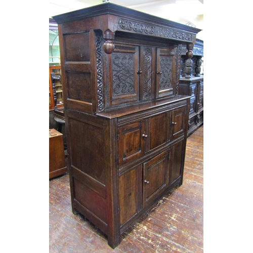 2701 - An old English oak court cupboard, enclosed by three panelled doors, the recessed upper section with... 