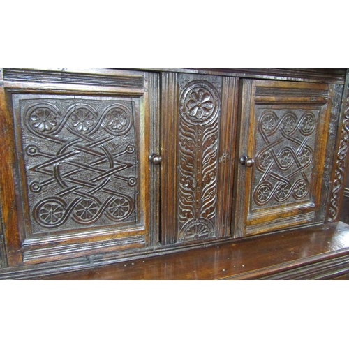 2701 - An old English oak court cupboard, enclosed by three panelled doors, the recessed upper section with... 