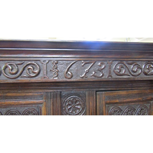 2701 - An old English oak court cupboard, enclosed by three panelled doors, the recessed upper section with... 