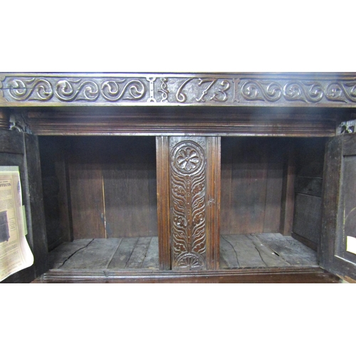 2701 - An old English oak court cupboard, enclosed by three panelled doors, the recessed upper section with... 