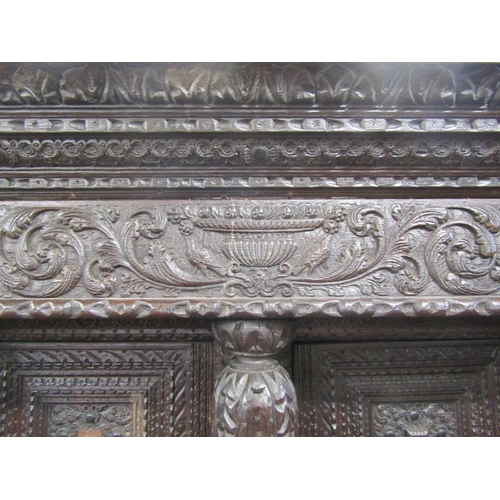 2725 - Substantial oak old English court cupboard with profuse carvings, with two panelled doors and large ... 