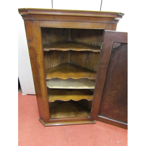 2726 - Georgian walnut hanging corner cupboard enclosed by a single panelled door and fitted shelves, 114cm... 