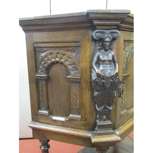 2727 - An Elizabethan style oak side cupboard, the central door flanked by two carved figures with open fra... 