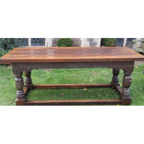 2731 - An old English oak refectory table, heavy planked top carved frieze on four turned supports, to seat... 