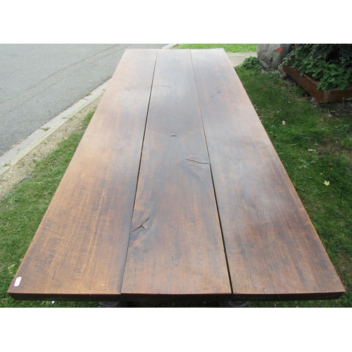 2731 - An old English oak refectory table, heavy planked top carved frieze on four turned supports, to seat... 