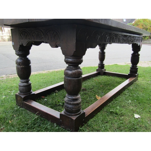 2731 - An old English oak refectory table, heavy planked top carved frieze on four turned supports, to seat... 