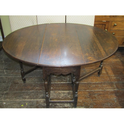 2737 - A Georgian oak gateleg dining table, 130cm long