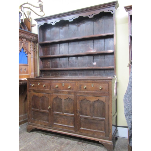 2746 - Regency oak dresser enclosed by two cupboards and three drawers, with ogee moulded outline, the boar... 