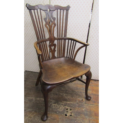 2748 - An 18th century Windsor elbow chair, principally in elm and fruit wood, with dished seat and shaped ... 