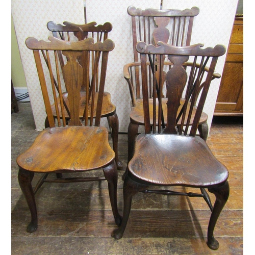 2751 - A carefully matched set of four (3+1) Georgian Windsor chairs principally in elm and other mixed woo... 