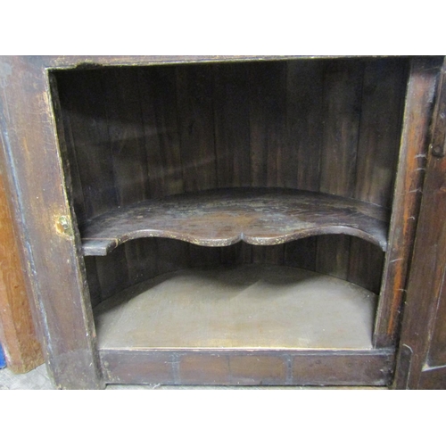 2756 - A Georgian and later oak barrel back freestanding corner cupboard, lower section with quarter panell... 