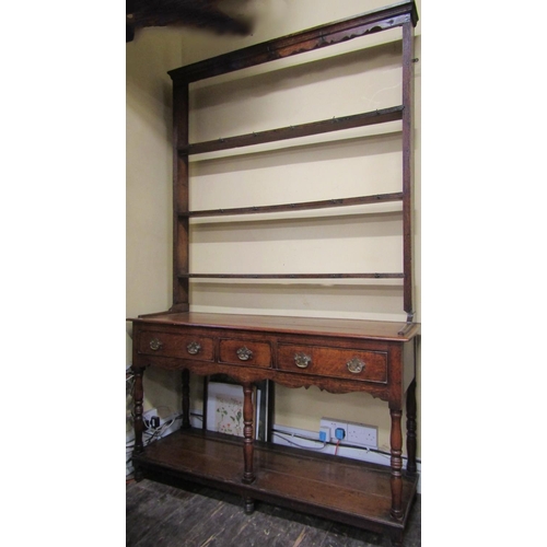 2759 - A small Georgian oak cottage pot board dresser, with three frieze drawers, the plate rack with three... 