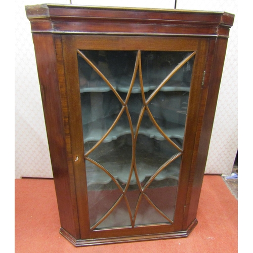 2760 - A Regency mahogany hanging corner cupboard with astragal glazed panelled door and painted interior