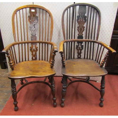 2765 - An almost identical matched pair of Georgian Windsor comb back elbow chairs in elm and yew wood, wit... 