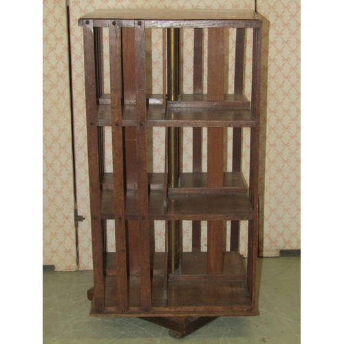 2334a - A small oak floorstanding revolving bookcase of square cut form, 36 cm square x 71 cm high