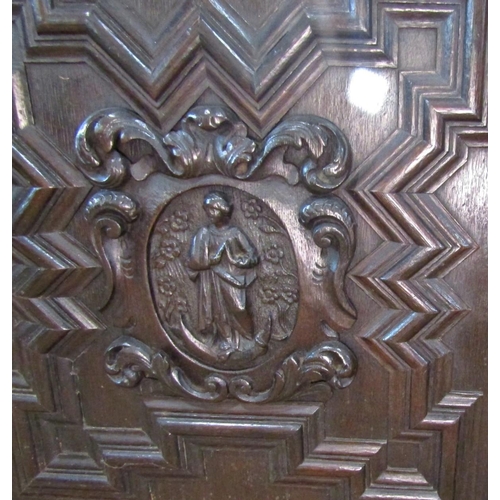 2344 - A substantial 19th century oak side cupboard enclosed by a pair of panelled doors, oval portrait pan... 