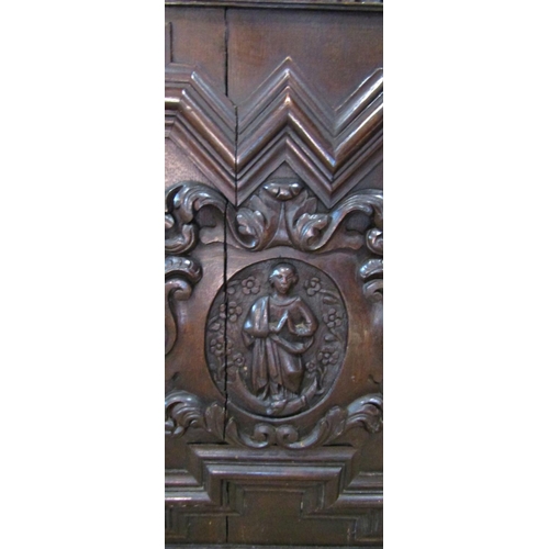 2344 - A substantial 19th century oak side cupboard enclosed by a pair of panelled doors, oval portrait pan... 