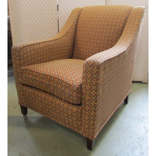 2359 - A reproduction easy chair with repeating floral sprig and lattice patterned upholstery, brass castor... 