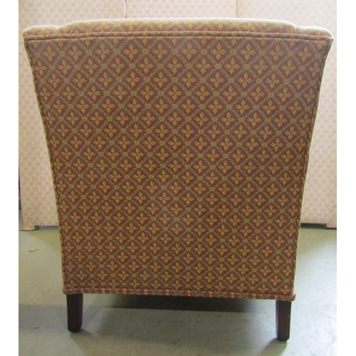 2359 - A reproduction easy chair with repeating floral sprig and lattice patterned upholstery, brass castor... 