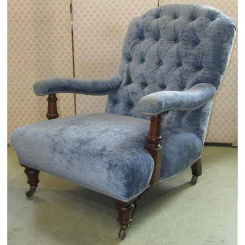 2369 - A Victorian low deep seated open arm chair, upholstered seat, button back and swept arms, the suppor... 