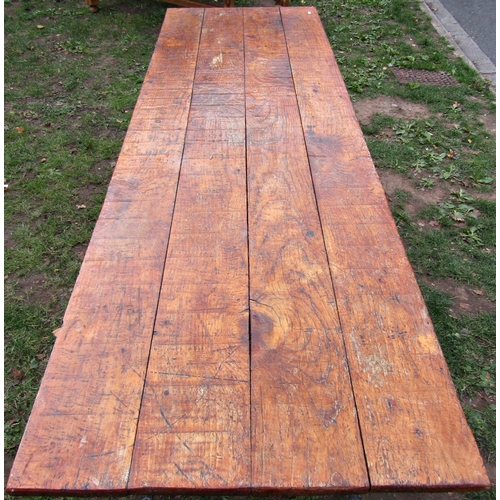 2387 - A rectangular rustic dining/work table, with old iron trestle supports, 221cm long x 72cm wide x 75c... 