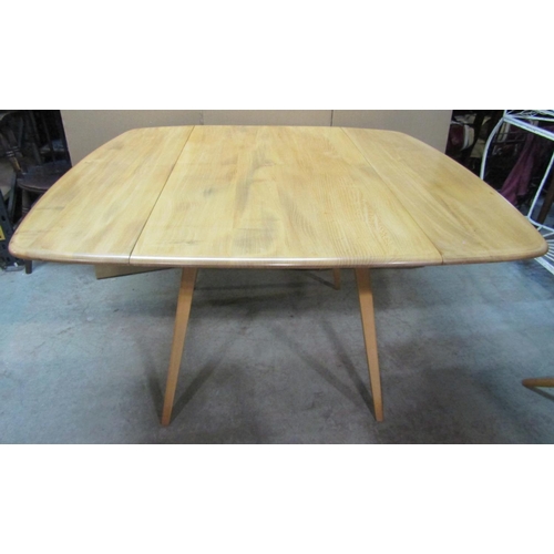 2392 - A vintage Ercol light elm and beechwood drop leaf dining table, with splayed supports, 110cm x 120cm... 