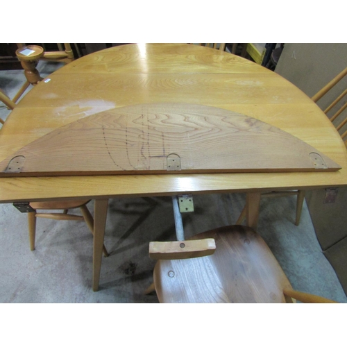 2393 - A vintage Ercol light elm and beechwood oval drop leaf dining table, raised on square tapered and sp... 