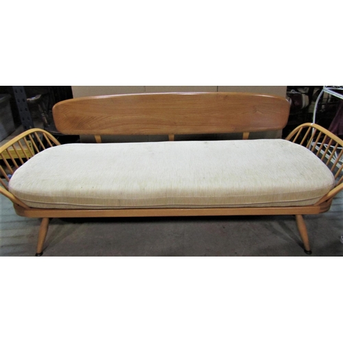 2395 - A vintage Ercol light elm and beechwood sofa bed, with panelled back, hoop and stick arms and loose ... 