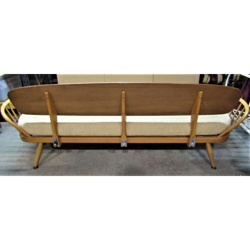 2395 - A vintage Ercol light elm and beechwood sofa bed, with panelled back, hoop and stick arms and loose ... 