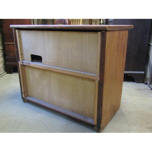 2415 - A rustic low stripped and waxed pine side cupboard enclosed by a pair of rectangular panelled doors,... 