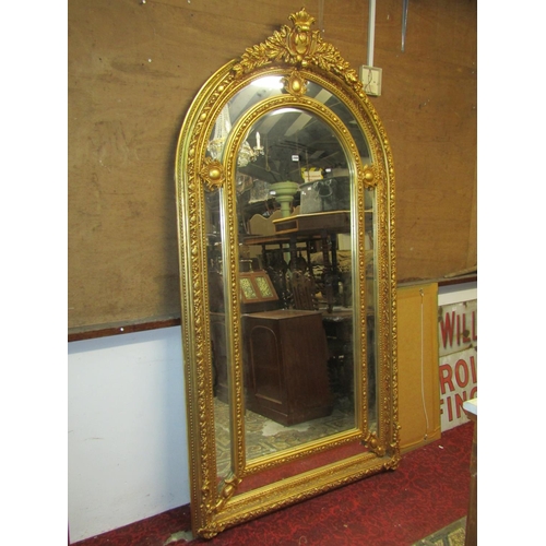 2489 - A substantial antique style wall mirror of arched form with central bevelled edge plate within a fur... 