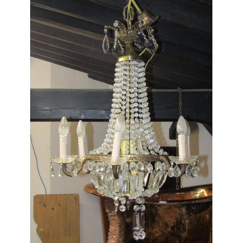 2495 - A gilt framed six branch chandelier, festooned with faceted drops, 80 cm drop approximately