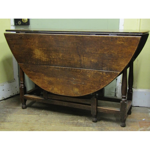 2688 - A Georgian oak gateleg table, on turned supports with frieze drawer, 119cm long