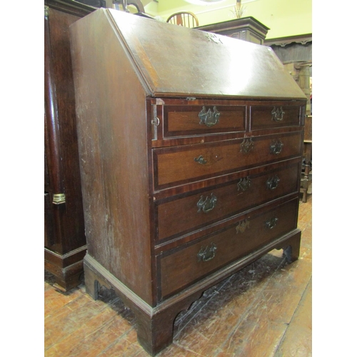 2692 - A Georgian oak bureau of three long and two short drawers, with fitted interior, with crossbanded fi... 