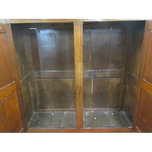 2700 - An 18th century oak livery cupboard enclosed by panelled doors with frieze drawers, 160cm wide x 175... 