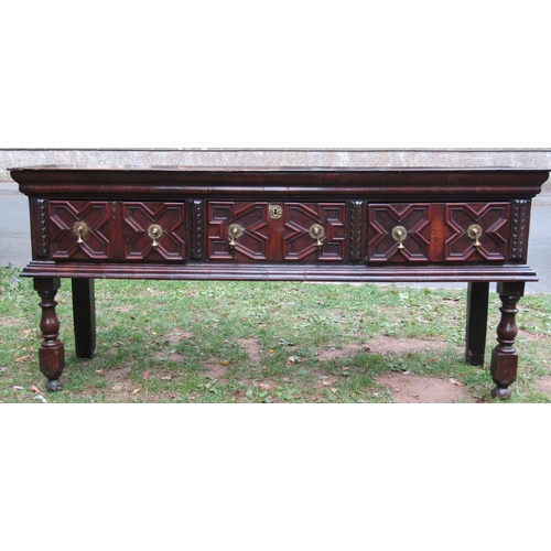 2717 - 17th century oak dresser base, incorporating three drawers with geometric block detail and panelled ... 