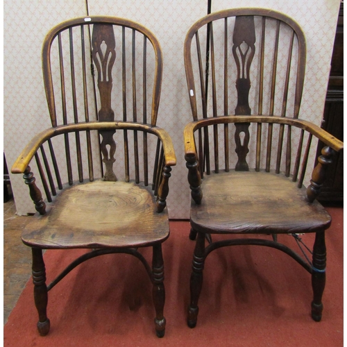 2757 - A matched pair of Georgian Windsor comb back elbow chairs principally in ash with dished seats, turn... 