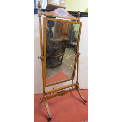 2775 - A Regency satinwood cheval glass, with turned columns beneath a shaped rail and urns, with hand pain... 