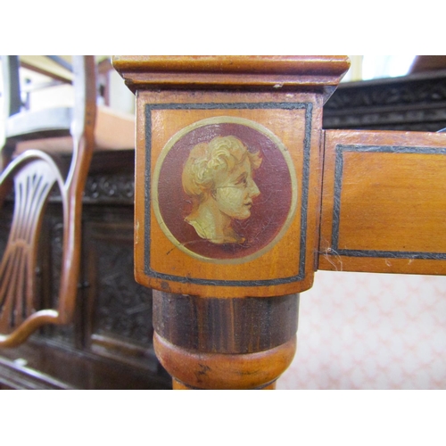 2775 - A Regency satinwood cheval glass, with turned columns beneath a shaped rail and urns, with hand pain... 