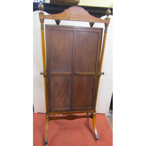 2775 - A Regency satinwood cheval glass, with turned columns beneath a shaped rail and urns, with hand pain... 