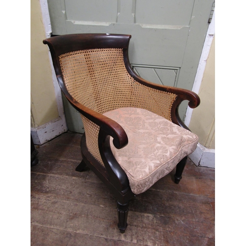 2780 - A 19th century mahogany bergere chair with scrolled back and arms