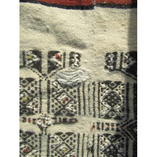 2501 - A West-African blanket with an intricate design of black line work on a natural wool ground, made-up... 