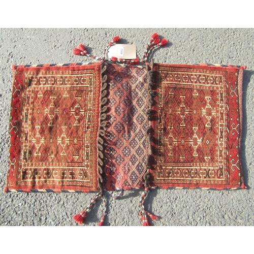 2503 - A Turkmen flat pannier bag and an Afghan flat weave mat, both with geometric indigo patterns on a ma... 