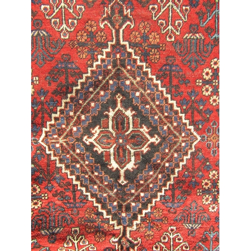 2508 - A North West Persian Josheghan rug with central diamond medallion and repeated floral patterns in to... 